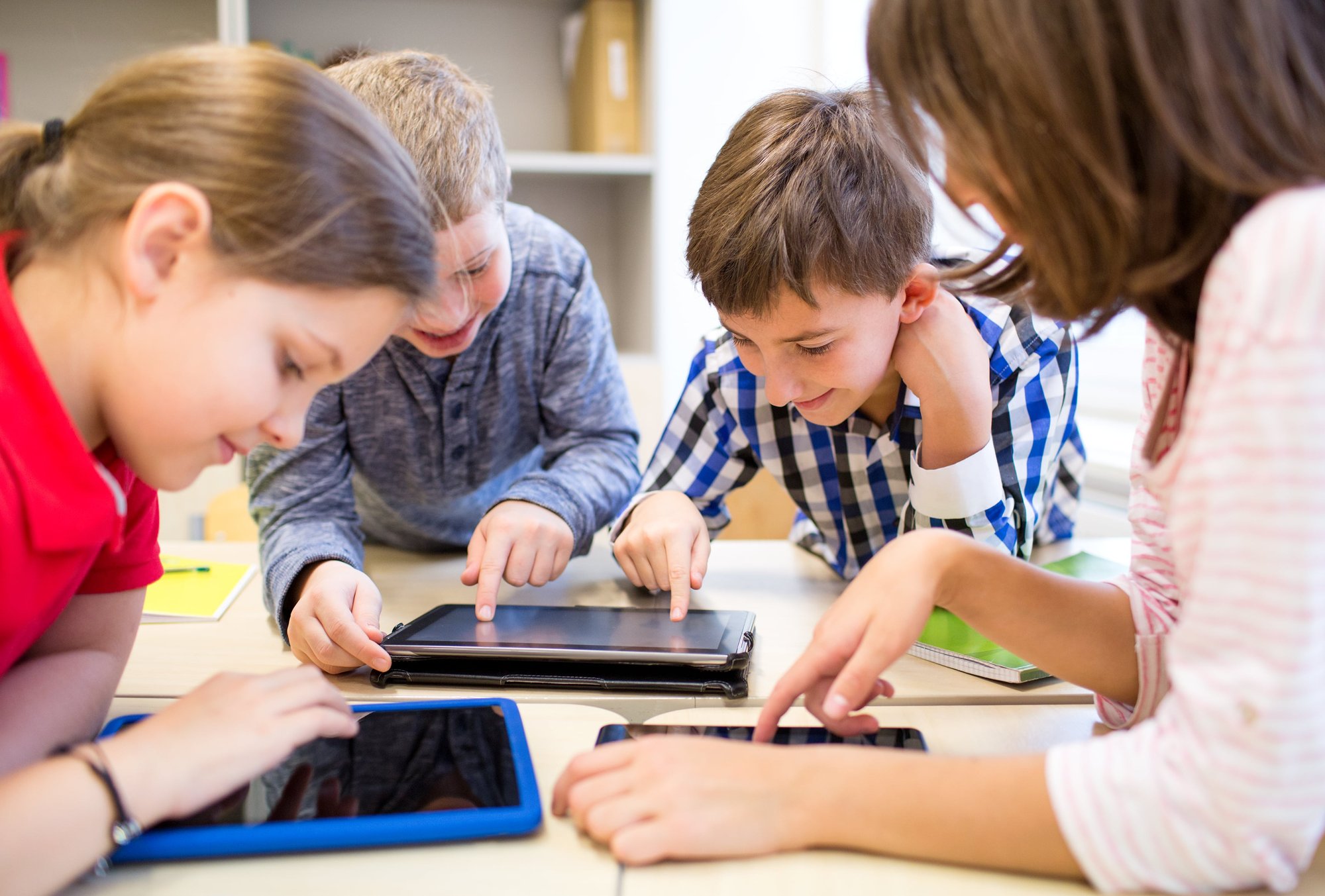 education-elementary-school-learning-technology-people-concept-group-school-kids-with-tablet-pc-computer-having-fun-break-clas